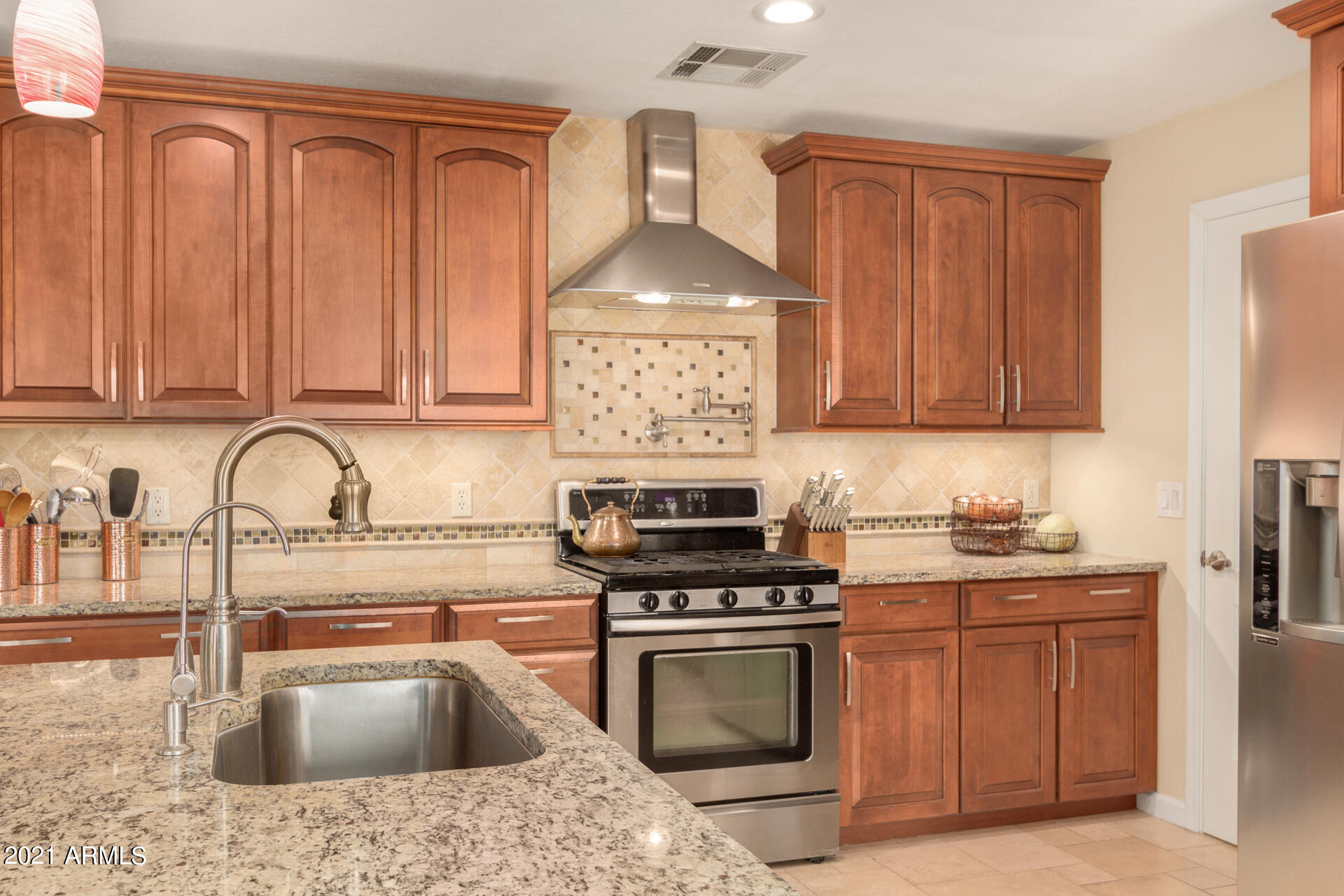1250 South Palm Street Gilbert, AZ 85296 - Photo 14 of 45 a kitchen with granite countertop a sink stainless steel appliances and cabinets