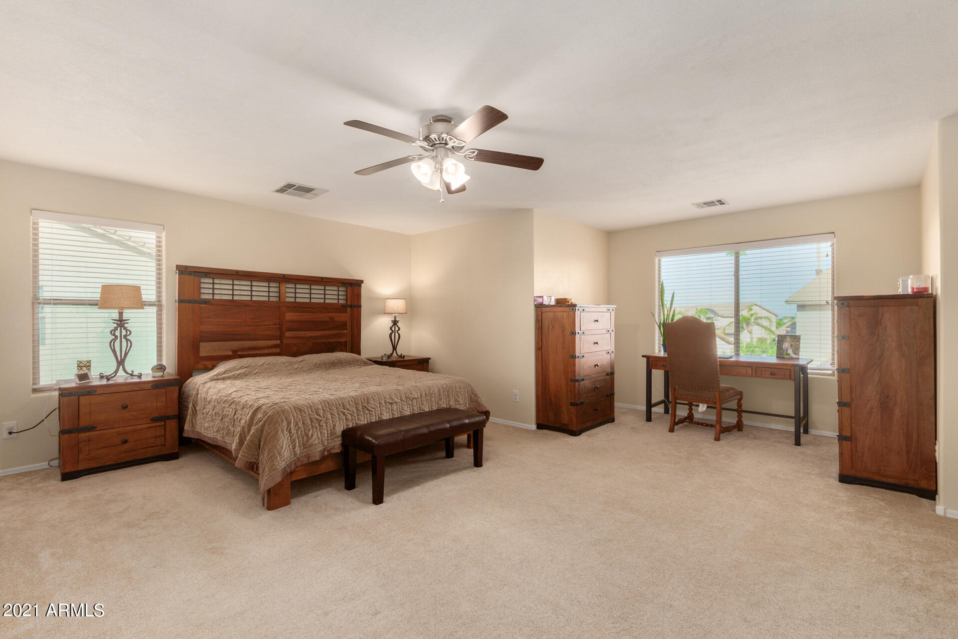 1250 South Palm Street Gilbert, AZ 85296 - Photo 19 of 45 a spacious bedroom with a bed and a chandelier