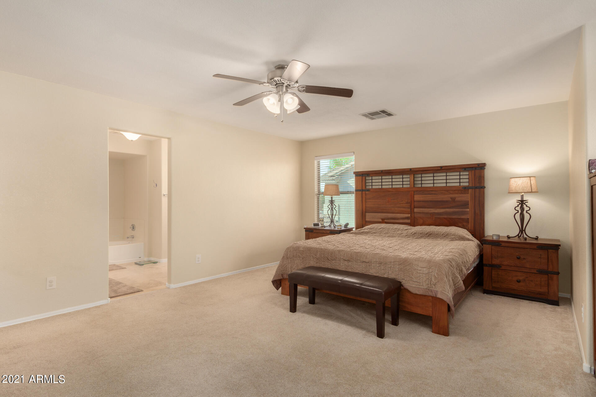 1250 South Palm Street Gilbert, AZ 85296 - Photo 20 of 45 a bedroom with a bed and a chandelier