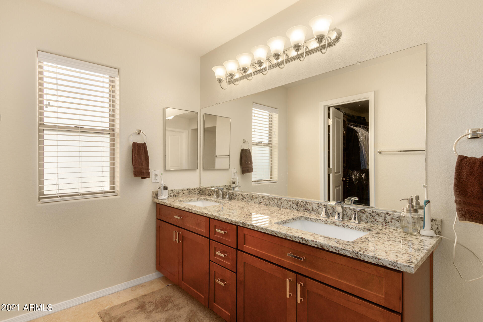 1250 South Palm Street Gilbert, AZ 85296 - Photo 22 of 45 a bathroom with a granite countertop sink and a mirror