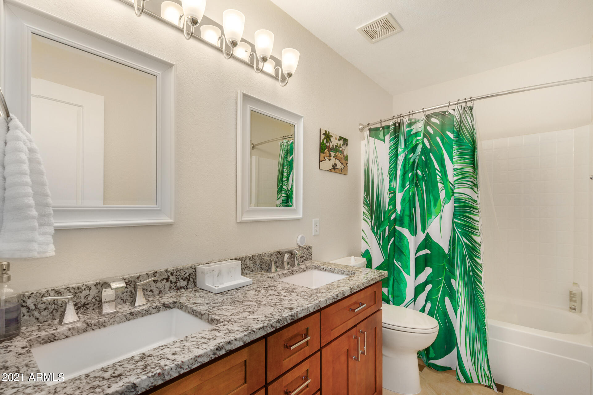 1250 South Palm Street Gilbert, AZ 85296 - Photo 29 of 45 a bathroom with a granite countertop sink a toilet and a bathtub