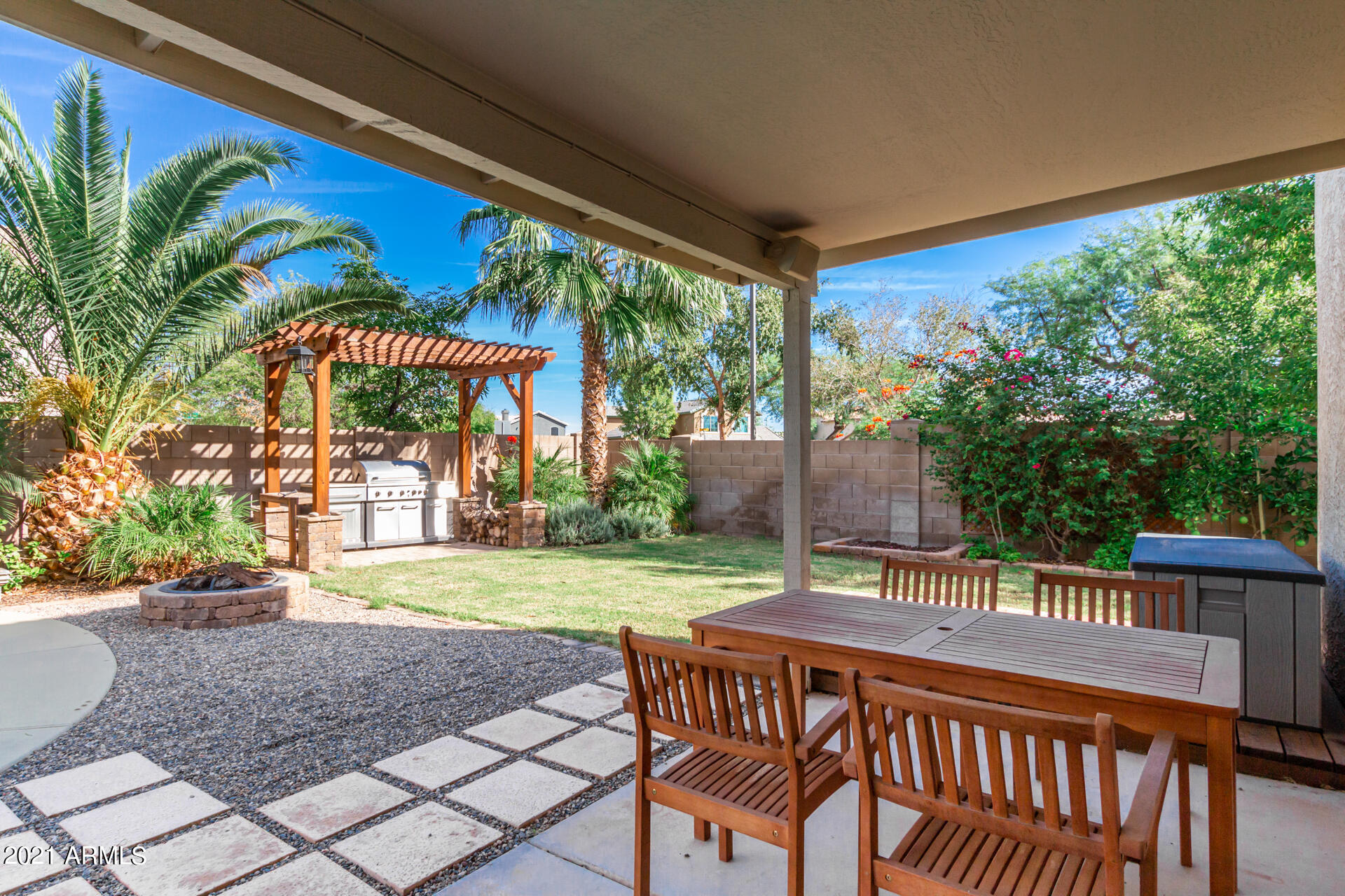 1250 South Palm Street Gilbert, AZ 85296 - Photo 33 of 45 a view of a patio with a table chairs and a backyard