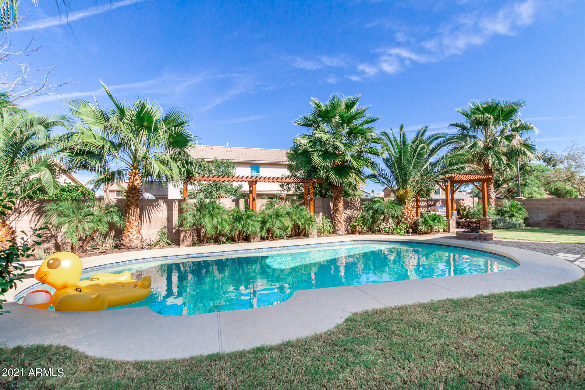 1250 South Palm Street Gilbert, AZ 85296 - Photo 41 of 45 a view of a swimming pool with a yard
