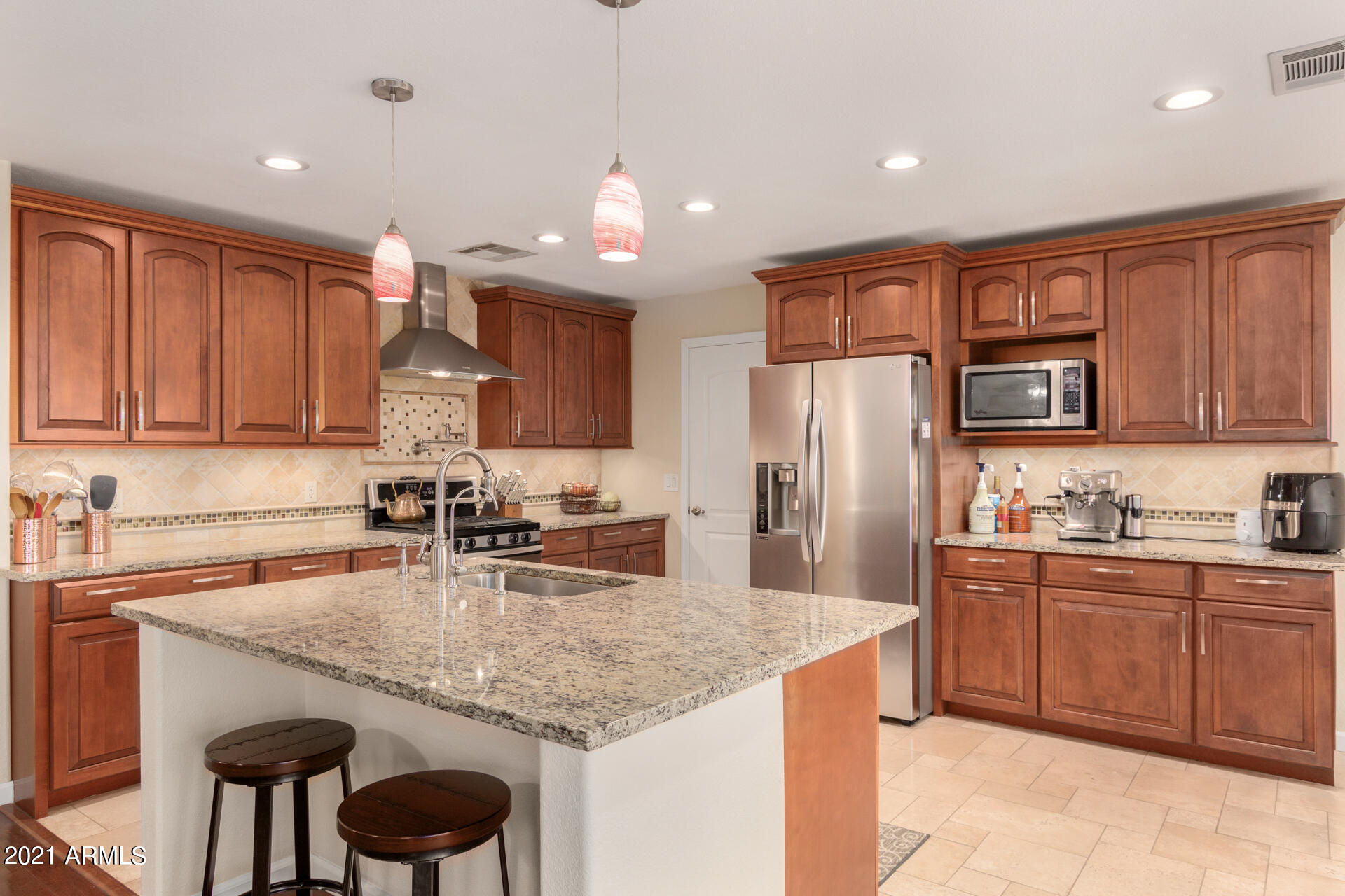 1250 South Palm Street Gilbert, AZ 85296 - Photo 10 of 45 a kitchen with stainless steel appliances granite countertop a sink refrigerator and cabinets