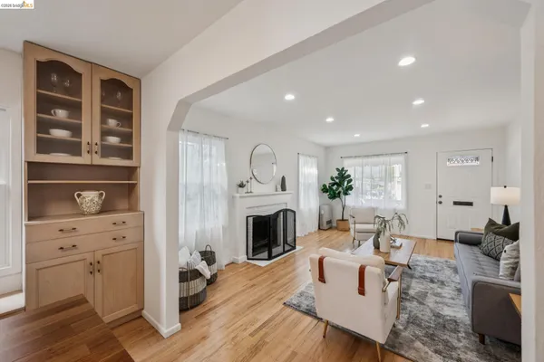a living room with furniture fireplace and wooden floor