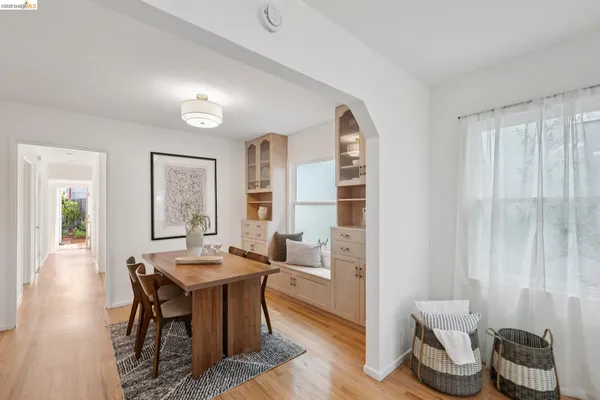 a dining room with furniture and wooden floor
