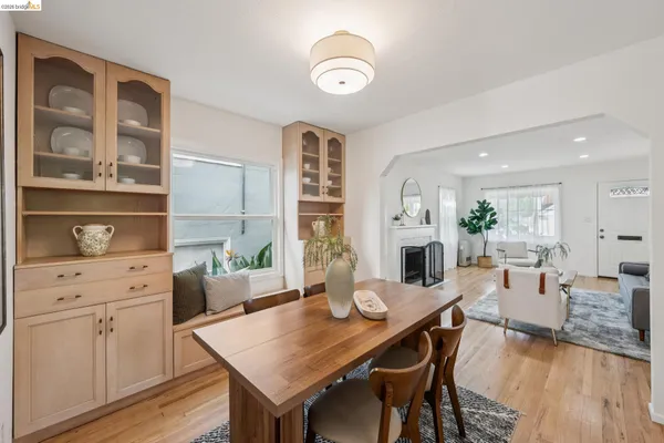 a living room with furniture fireplace and wooden floor