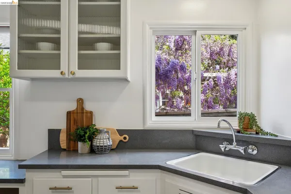 a kitchen with sink and wooden floor
