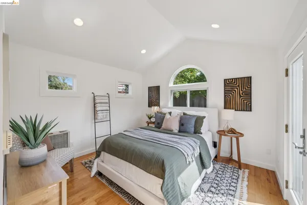 a bedroom with a bed and a painting on the wall