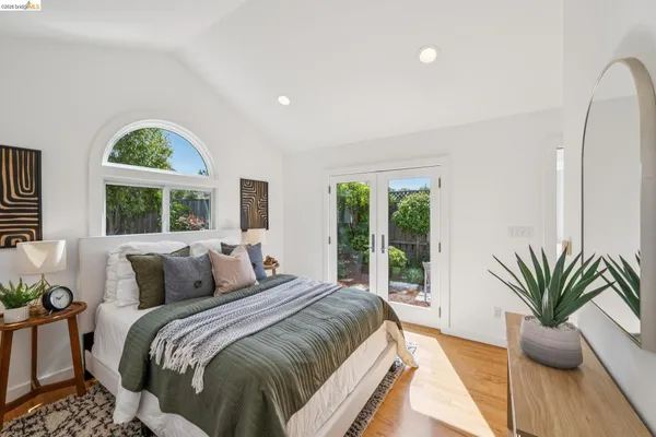 a bedroom with a large bed and a large window