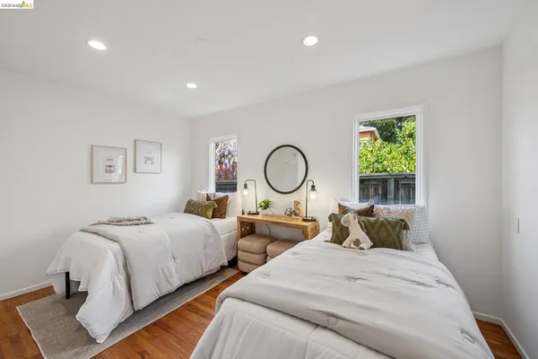 a bedroom with two beds and a window