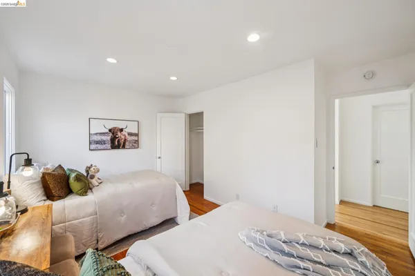 a bedroom with two beds and a lamp