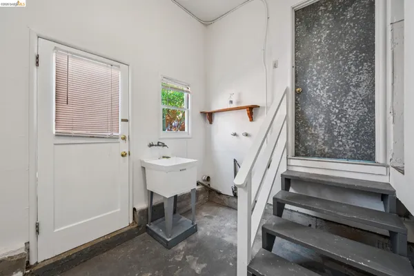 a bathroom with a sink a toilet and a window