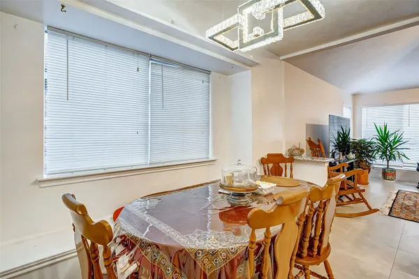 a dining room with furniture and window