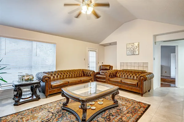 a living room with furniture a rug and a window
