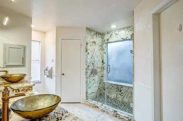 a bathroom with a sink toilet and shower