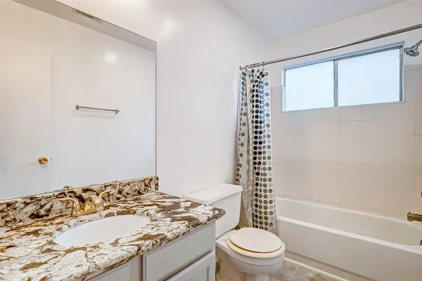 a bathroom with a sink a toilet and a bathtub