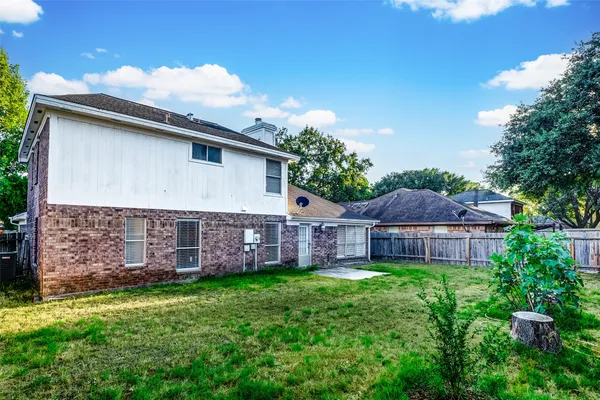 a view of a house with a backyard and a patio