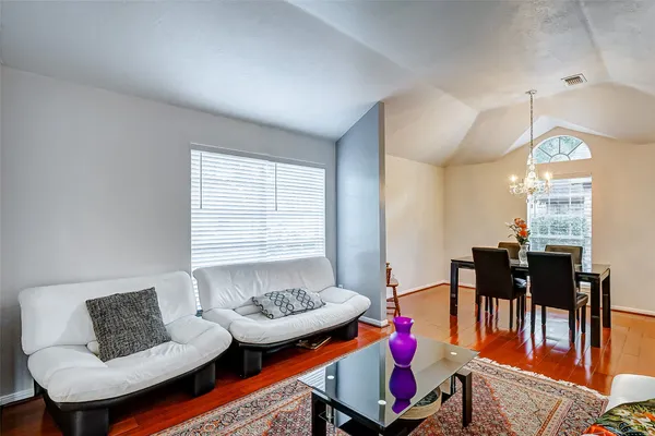 a living room with furniture and wooden floor