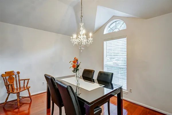 a view of a dining room with furniture and chandelier