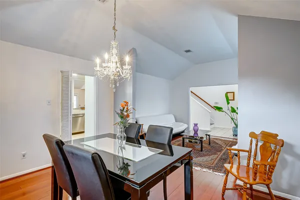 a view of a dining room with furniture and chandelier