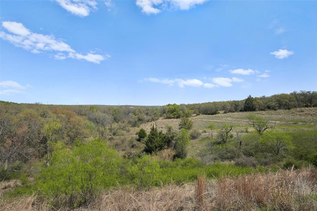 2202 County Road 3657 Springtown, TX 76082 - Photo 1 of 34 a view of a lake in middle of a field