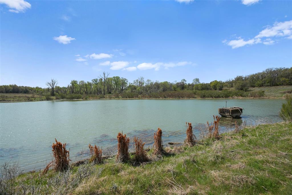 2202 County Road 3657 Springtown, TX 76082 - Photo 16 of 34 a view of a lake with houses in the back