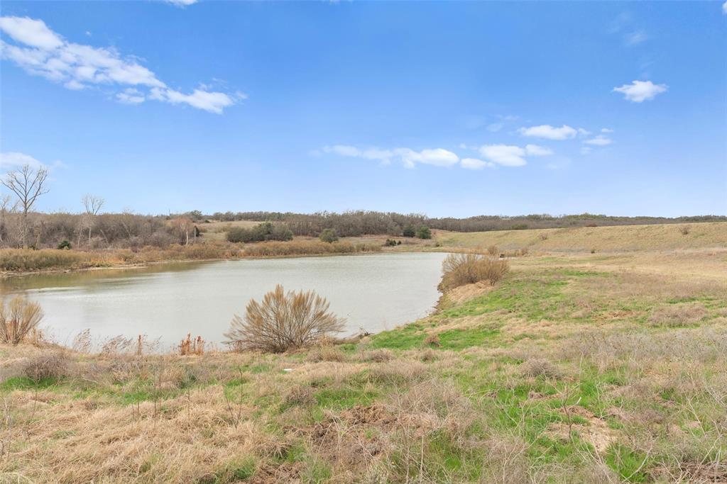 2202 County Road 3657 Springtown, TX 76082 - Photo 20 of 34 a view of a lake from a yard