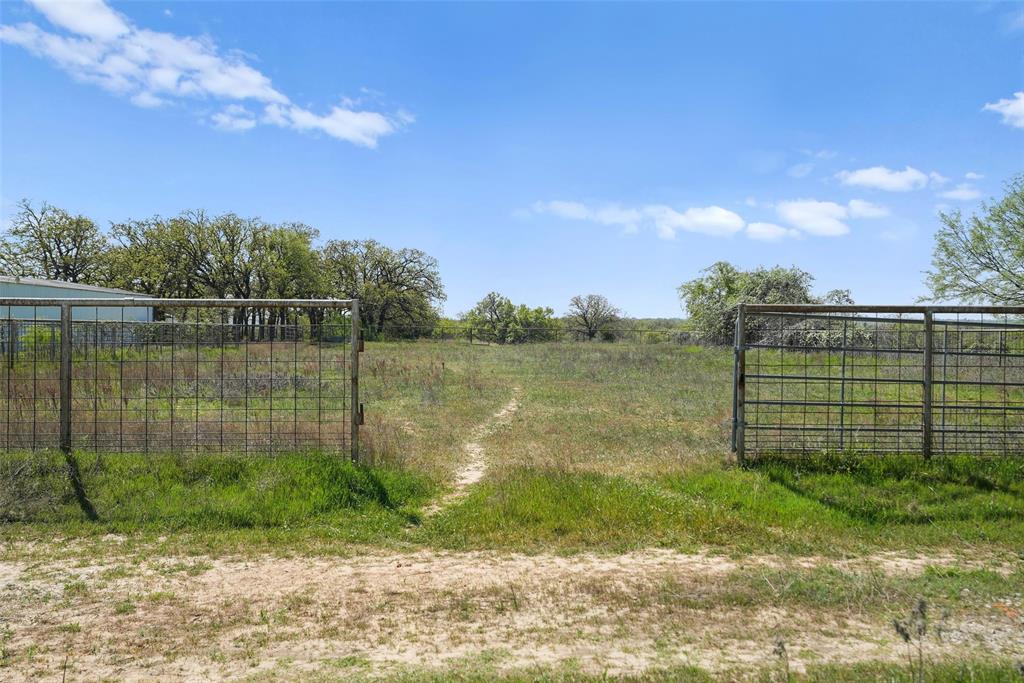 2202 County Road 3657 Springtown, TX 76082 - Photo 27 of 34 a view of a lake with a big yard