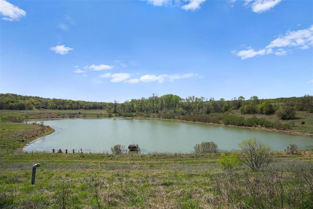 2202 County Road 3657 Springtown, TX 76082 - Photo 3 of 34 a view of a lake from a yard