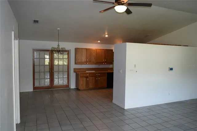 a kitchen with stainless steel appliances a refrigerator and a stove top oven