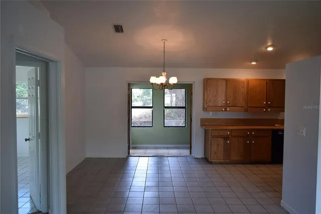 a open kitchen with granite countertop a refrigerator and a sink