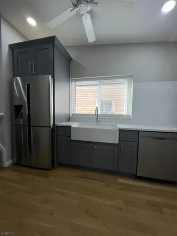 a kitchen with stainless steel appliances granite countertop a refrigerator and a sink