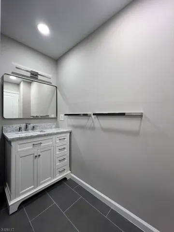 a bathroom with a sink and mirror