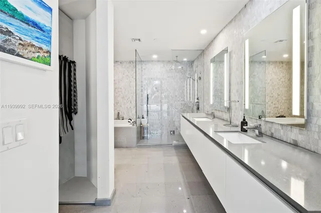 a bedroom with a bed a large window and potted plant