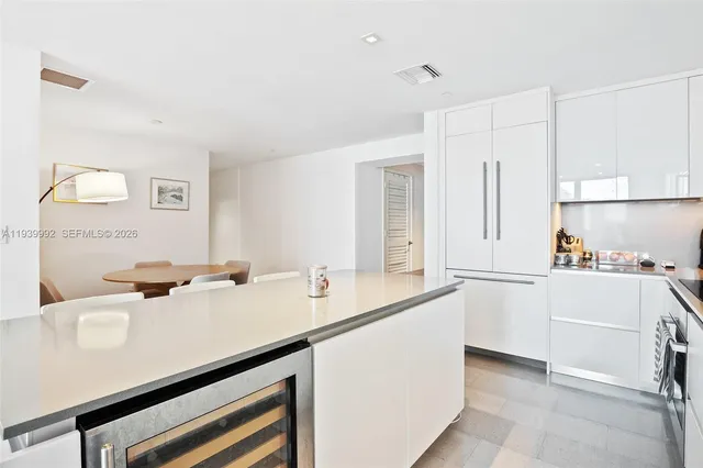 a spacious bedroom with a large bed and a large window