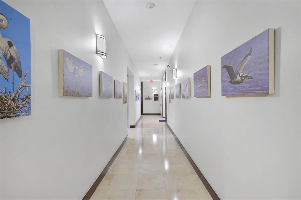 a view of a hallway with paintings on the wall