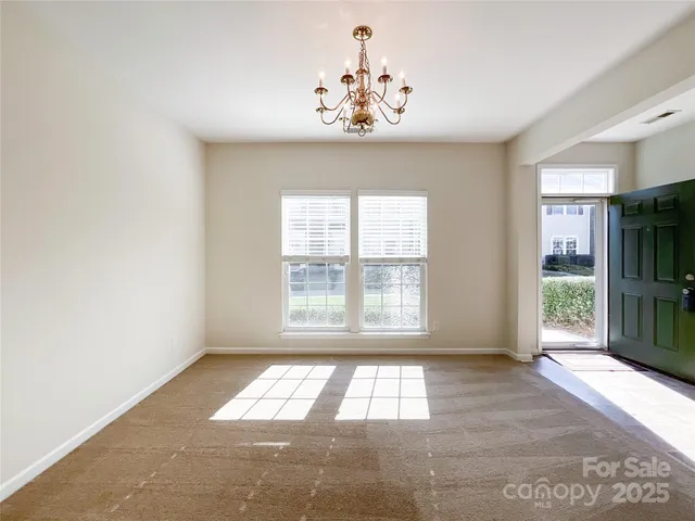 a view of a hallway with wooden floor and a bathroom