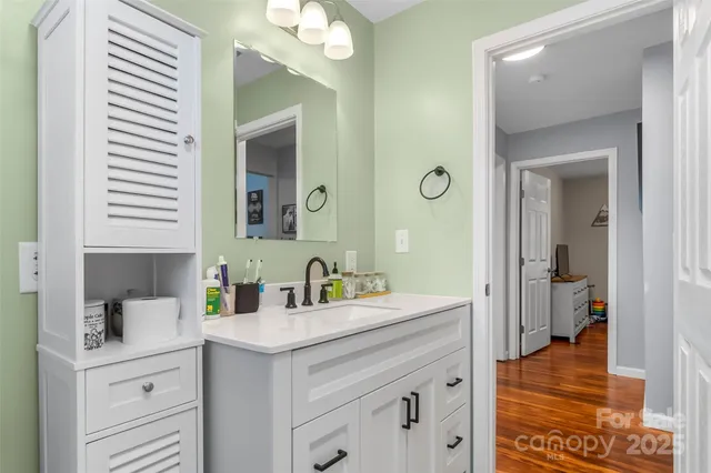 a en suite bathroom with a sink double vanity and a mirror