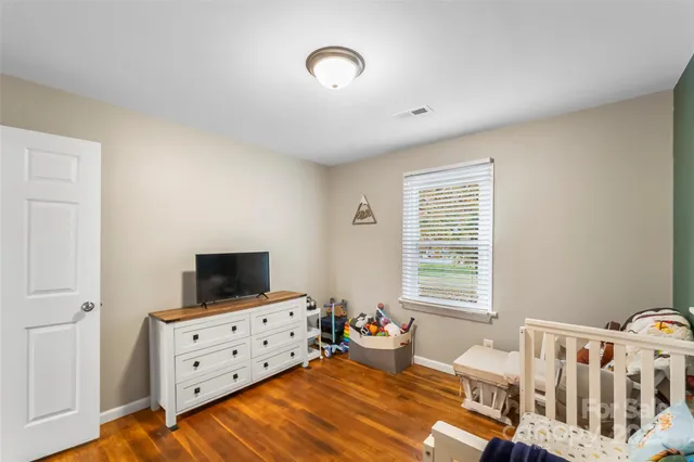 a bedroom with furniture and a flat screen tv