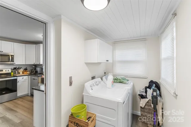 a kitchen with a sink appliances and cabinets