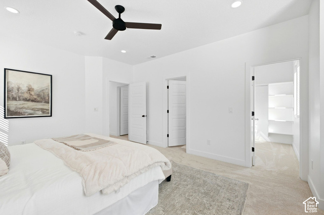 153 East Rochefort Court Sandy, UT 84070 - Photo 17 of 43 Primary bedroom. Neutral tone wall paint, recessed ceiling lighting, ceiling fan with dark blades, light-colored carpet flooring, and white paneled doors