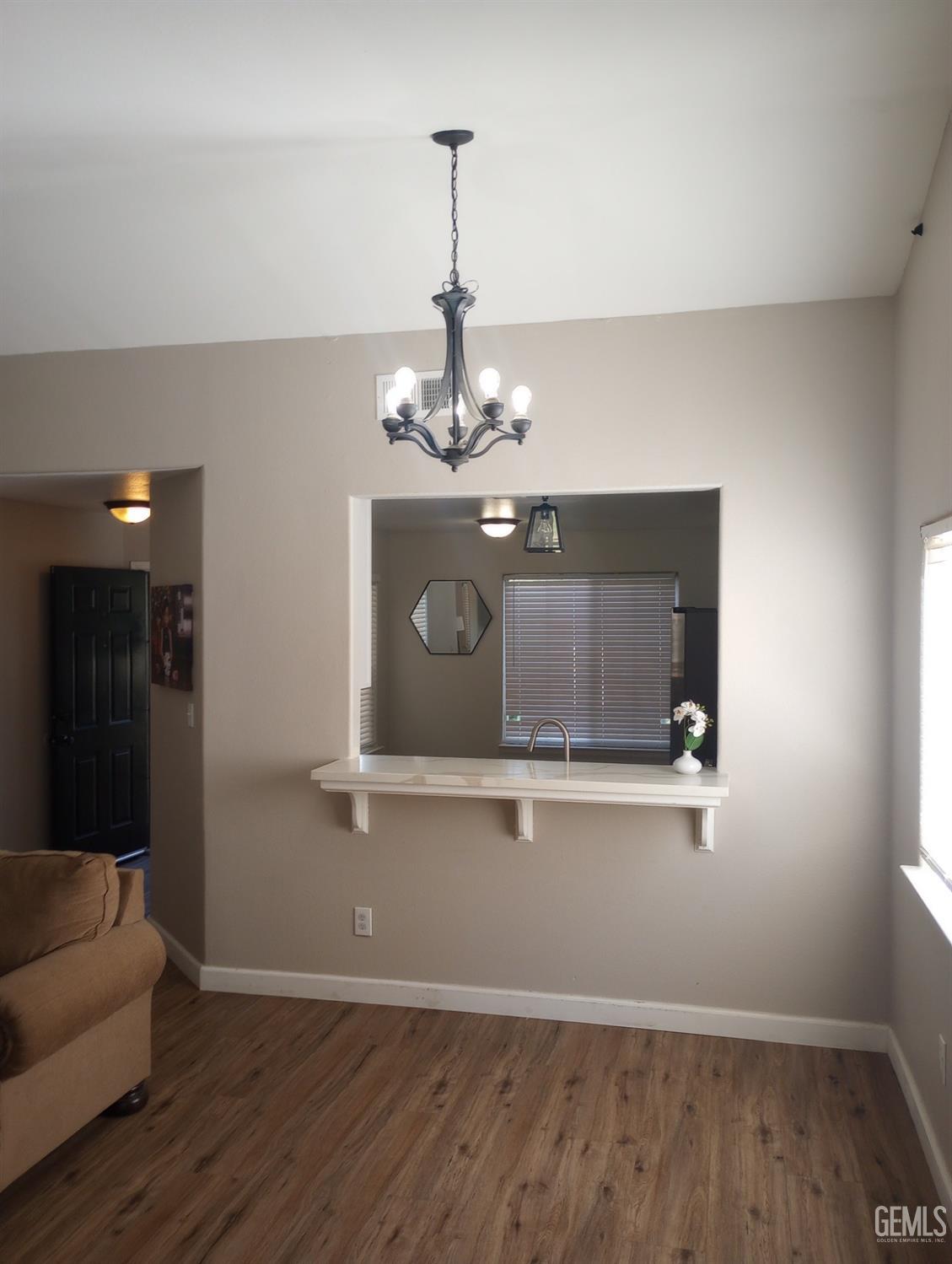 Undisclosed Address Bakersfield, CA 93313 - Photo 8 of 18 a living room with wooden floor and ceiling fan