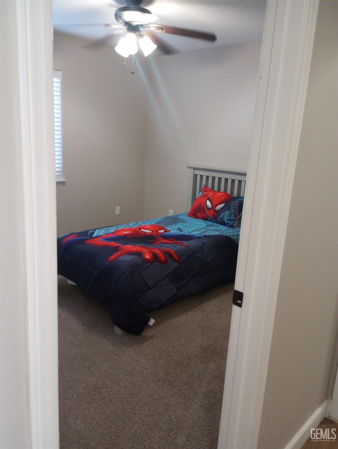 Undisclosed Address Bakersfield, CA 93313 - Photo 9 of 18 a bedroom with a bed and a chandelier