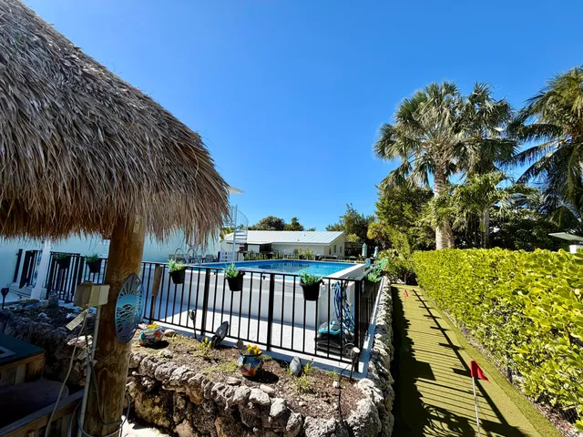 a view of a house with backyard and sitting area