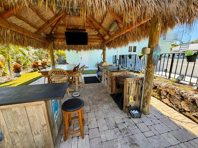 a view of a patio with table and chairs potted plants