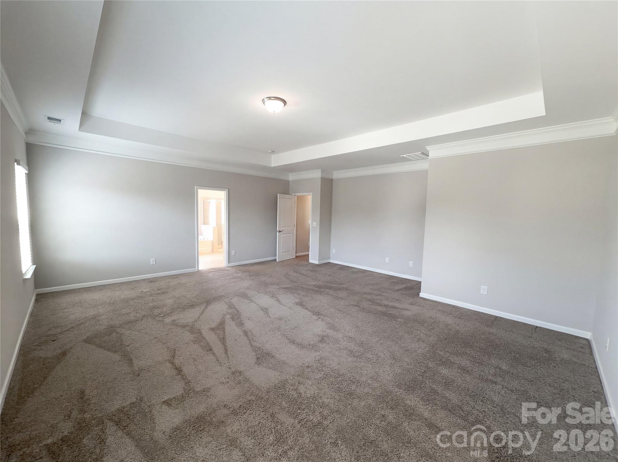 617 Ardsley Drive Locust, NC 28097 - Photo 4 of 23 a view of an empty room with window and wooden floor