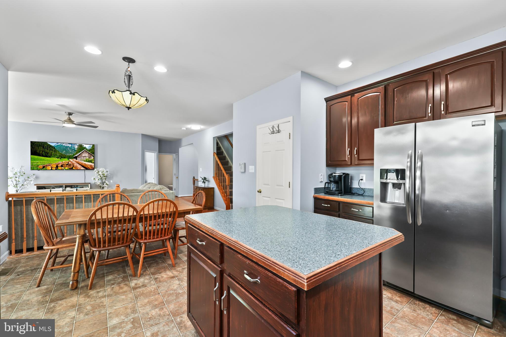 44 Hamstead Road Fredericksburg, VA 22405 - Photo 12 of 53 a kitchen with stainless steel appliances a table chairs and refrigerator