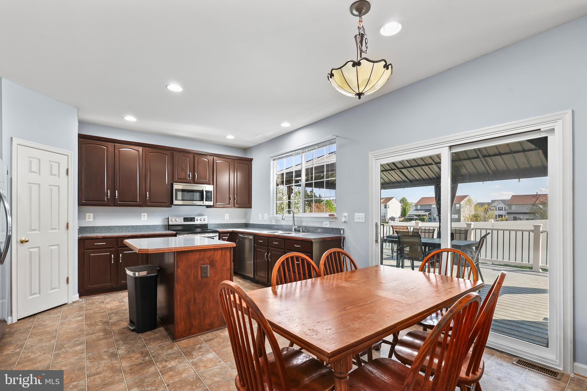 44 Hamstead Road Fredericksburg, VA 22405 - Photo 14 of 53 a kitchen with stainless steel appliances granite countertop a kitchen island a stove a table and chairs