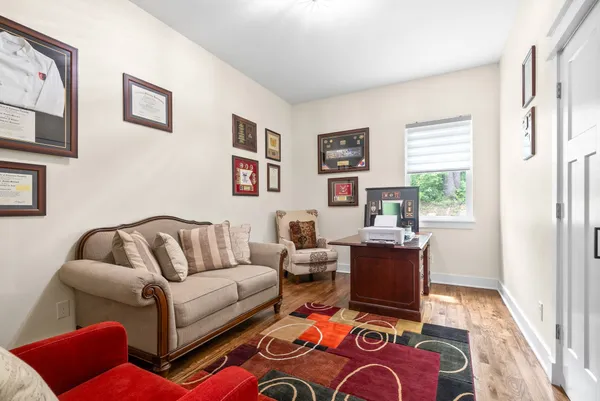 a view of balcony with wooden floor and outdoor seating